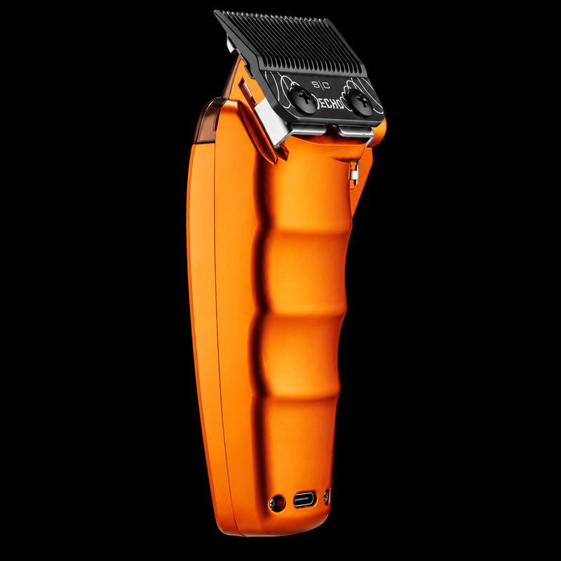 StyleCraft Saber 2.0 orange clipper angled back view showing ribbed metal grip and Echo blade on black background