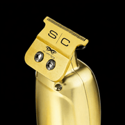 Gold hair clipper with 'S/C' branding on a black background