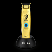 Gold electric shaver with 'Saber' branding on a black background