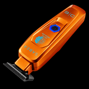 StyleCraft Saber orange trimmer lying diagonally with T-blade pointing down, digital brushless badge visible