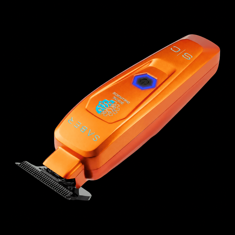 StyleCraft Saber orange professional hair trimmer SC421O angled view on black background