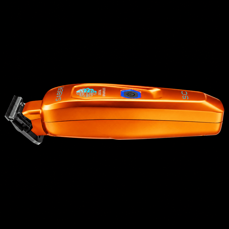 StyleCraft Saber orange trimmer lying flat in side profile showing slim metal body and T-blade on black background