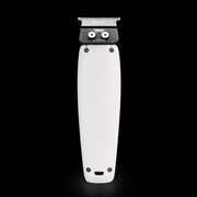 White grooming clipper with black top on a black background
