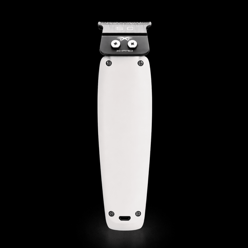 White grooming clipper with black top on a black background
