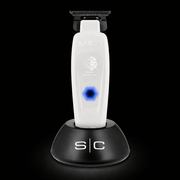 Saber grooming tool on a black stand with a dark background