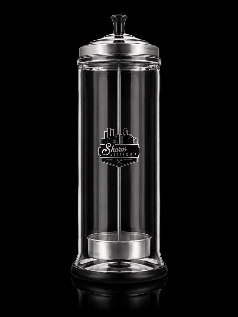 Clear glass container with silver lid and base, featuring a logo on a black background