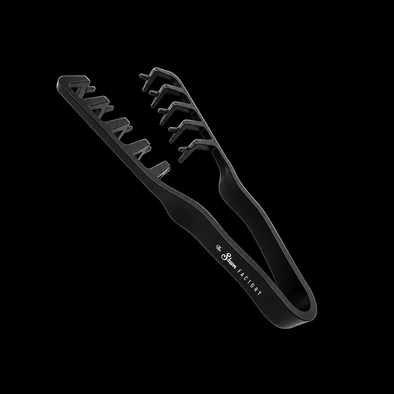 The Shave Factory Hair Texture Tongs in black, angled top view showing the interlocking texturizing teeth on a black background