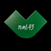 Green plastic tool with 'Tomb 45' branding on a black background