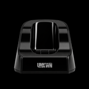 A glossy black charging dock with the brand name 'UNKN' printed in white on the front, set against a solid black background.