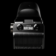 A close-up studio shot of a black and silver electric hair clipper head against a solid black background, showing the brand name 'UNIQ' and model 'BO28F' on the metal body.
