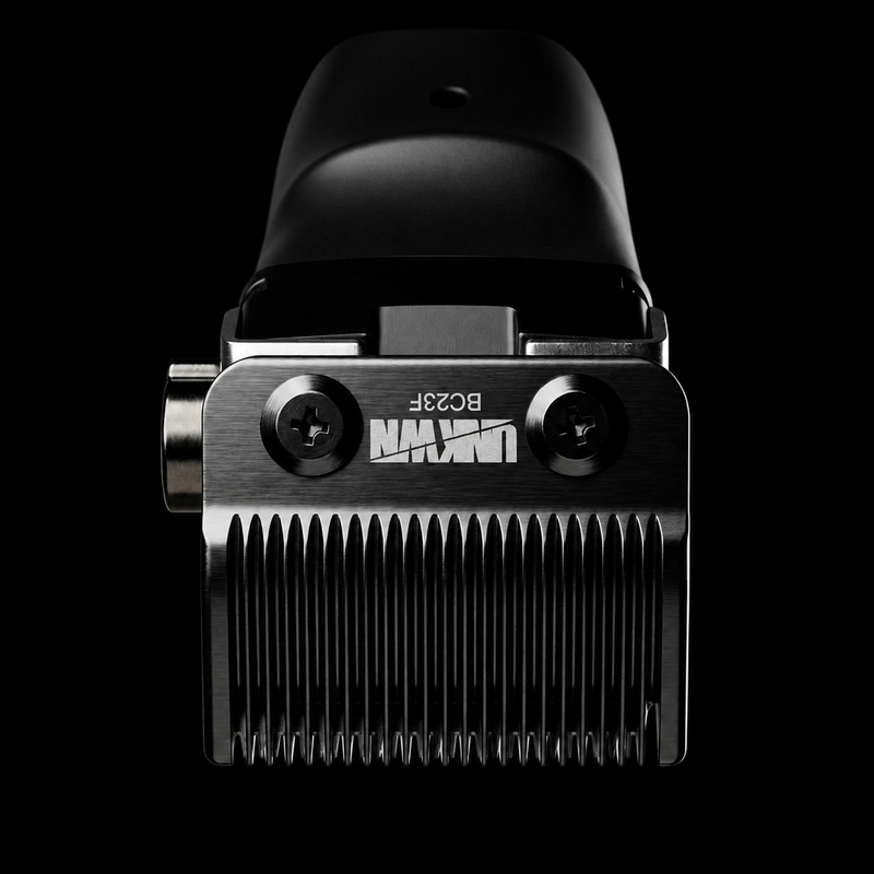 A close-up studio shot of a black and silver electric hair clipper head against a solid black background, showing the brand name 'UNIQ' and model 'BO28F' on the metal body.