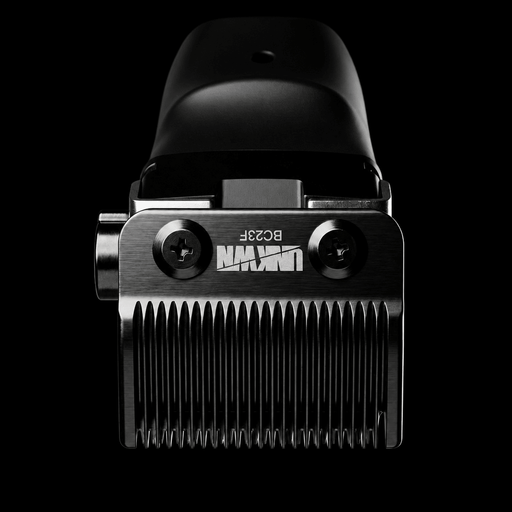 A close-up studio shot of a black and silver electric hair clipper head against a solid black background, showing the brand name 'UNIQ' and model 'BO28F' on the metal body.