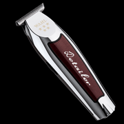 Hair trimmer with a maroon handle and silver top on a black background